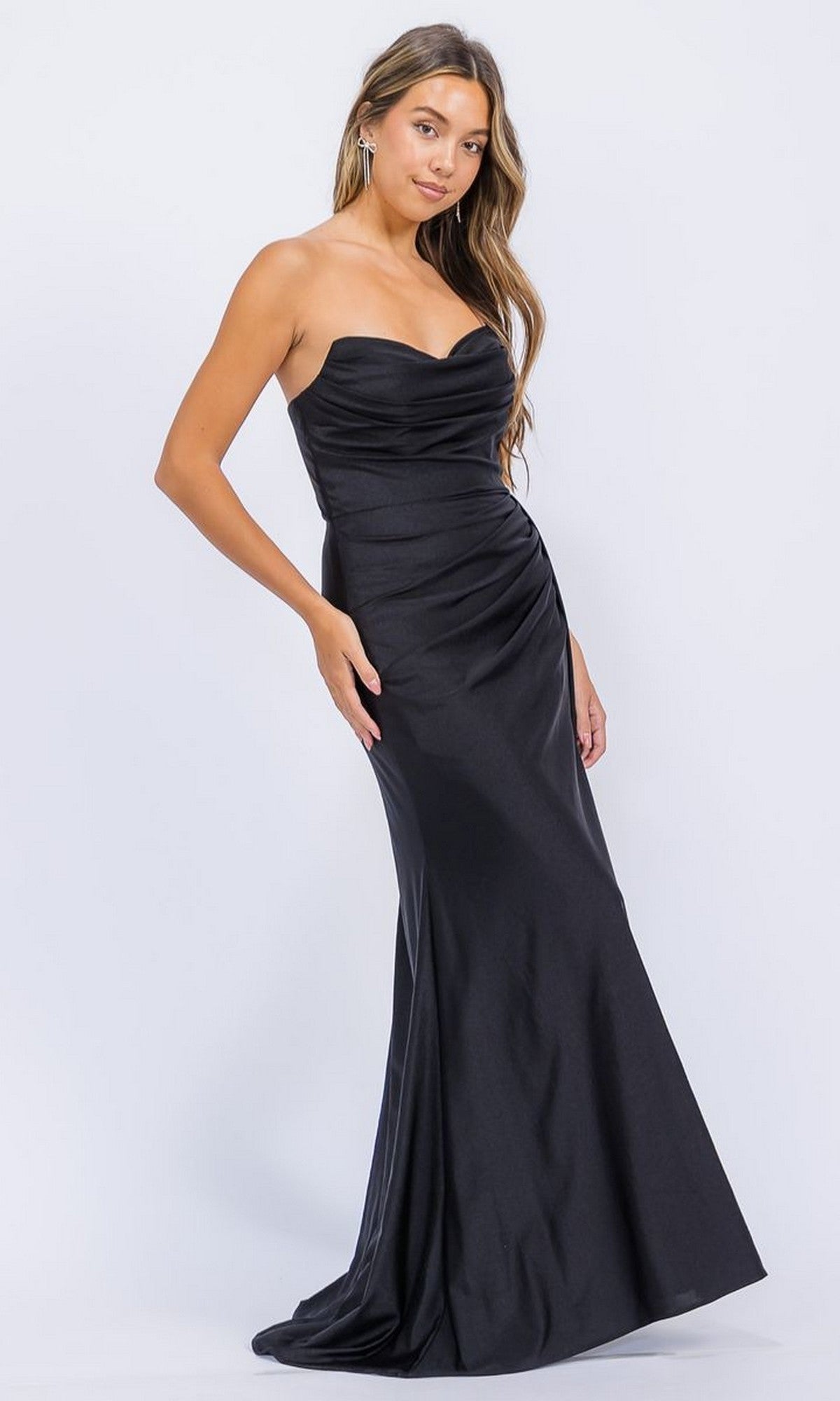 A woman poses gracefully against a plain light background in the Eureka EK178—a long, elegant, fitted black strapless prom dress.